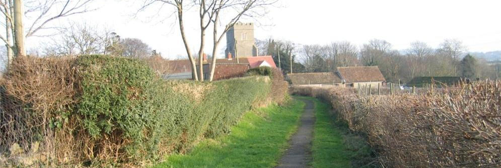 Village footpath leading towards St George's Church in Wembdon Somerset