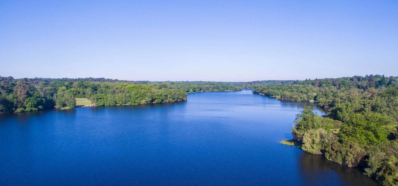 Virginia Water lake surrounded by woodland in Surrey