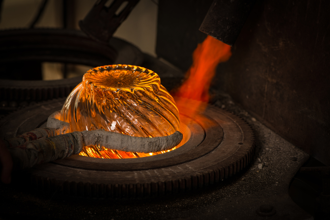 Molten glass being shaped at Dartington Glass Factory in Devon