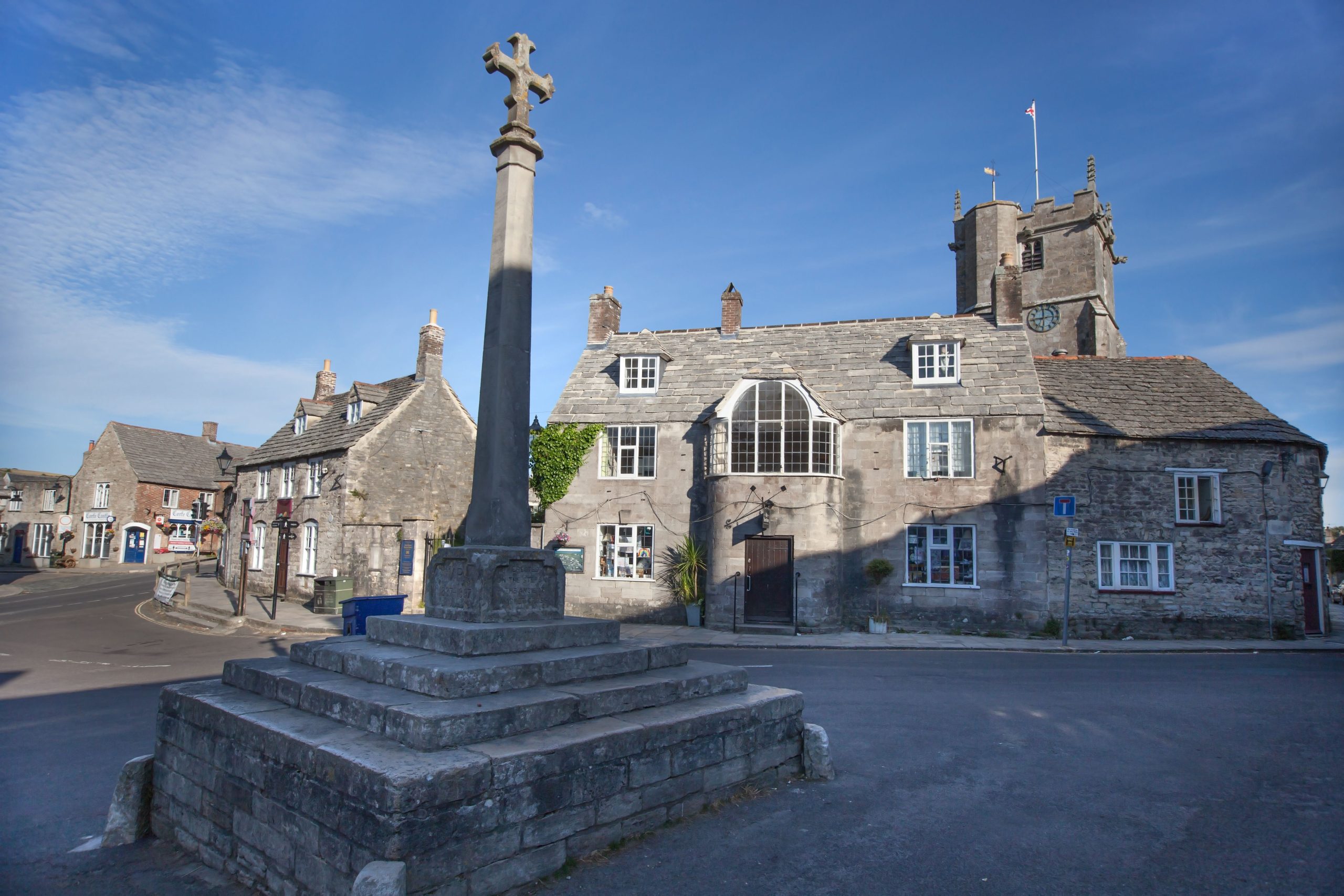 Historic stone cross and traditional buildings in Langport, Somerset