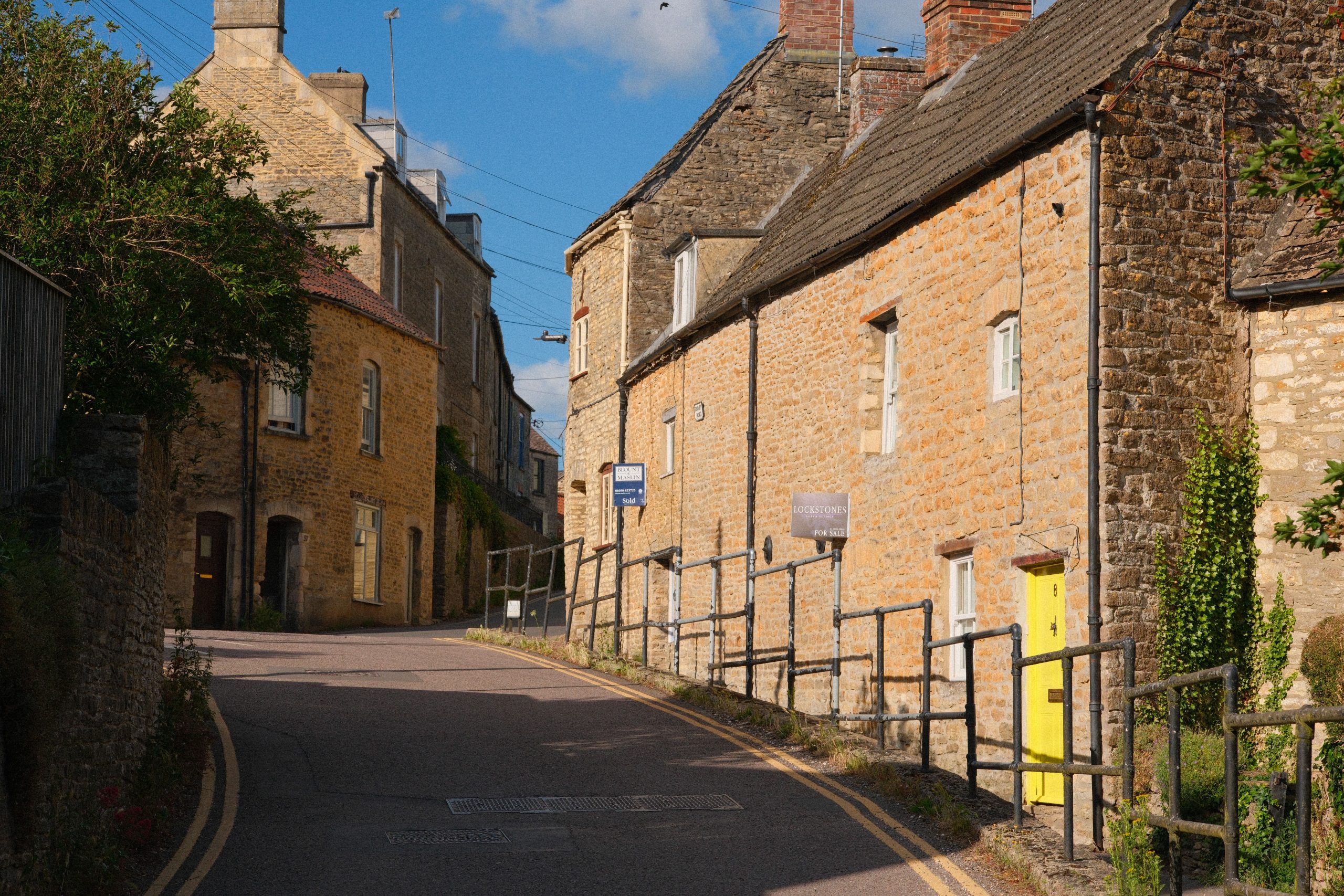 Traditional Hamstone homes on a historic street in Martock, Somerset