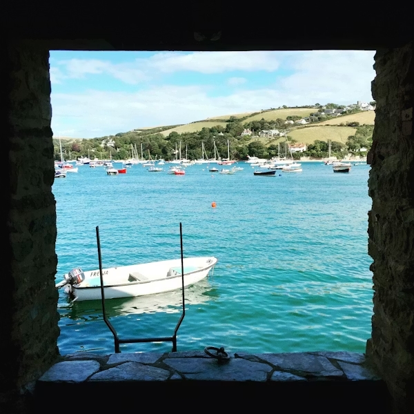 View across Salcombe estuary with boats and hillside homes in South Devon