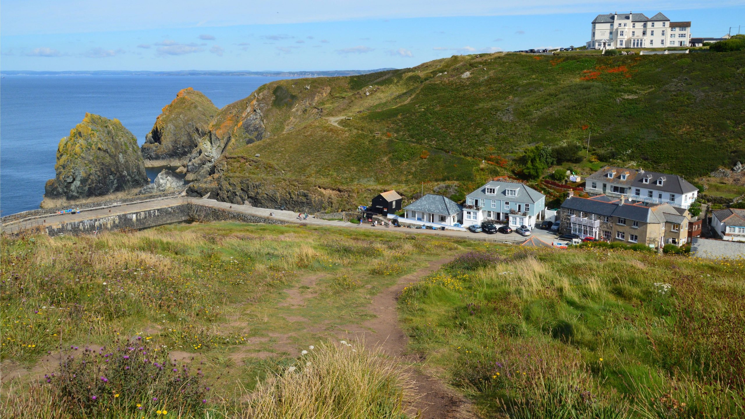 Rocky coastal headland and Breakwater Road overlooking the sea at Bude Cornwall