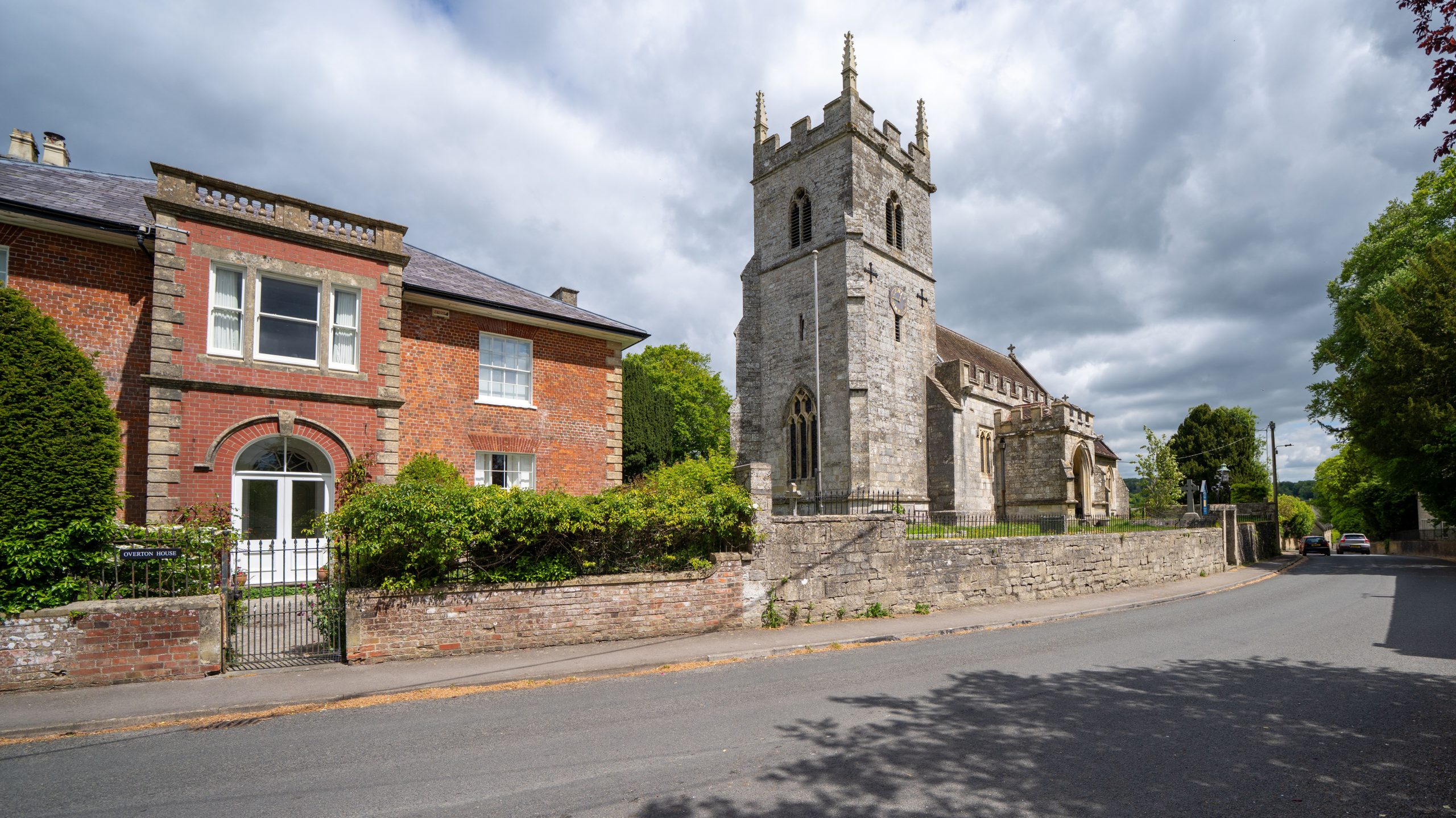 Historic stone parish church and traditional buildings on a village street