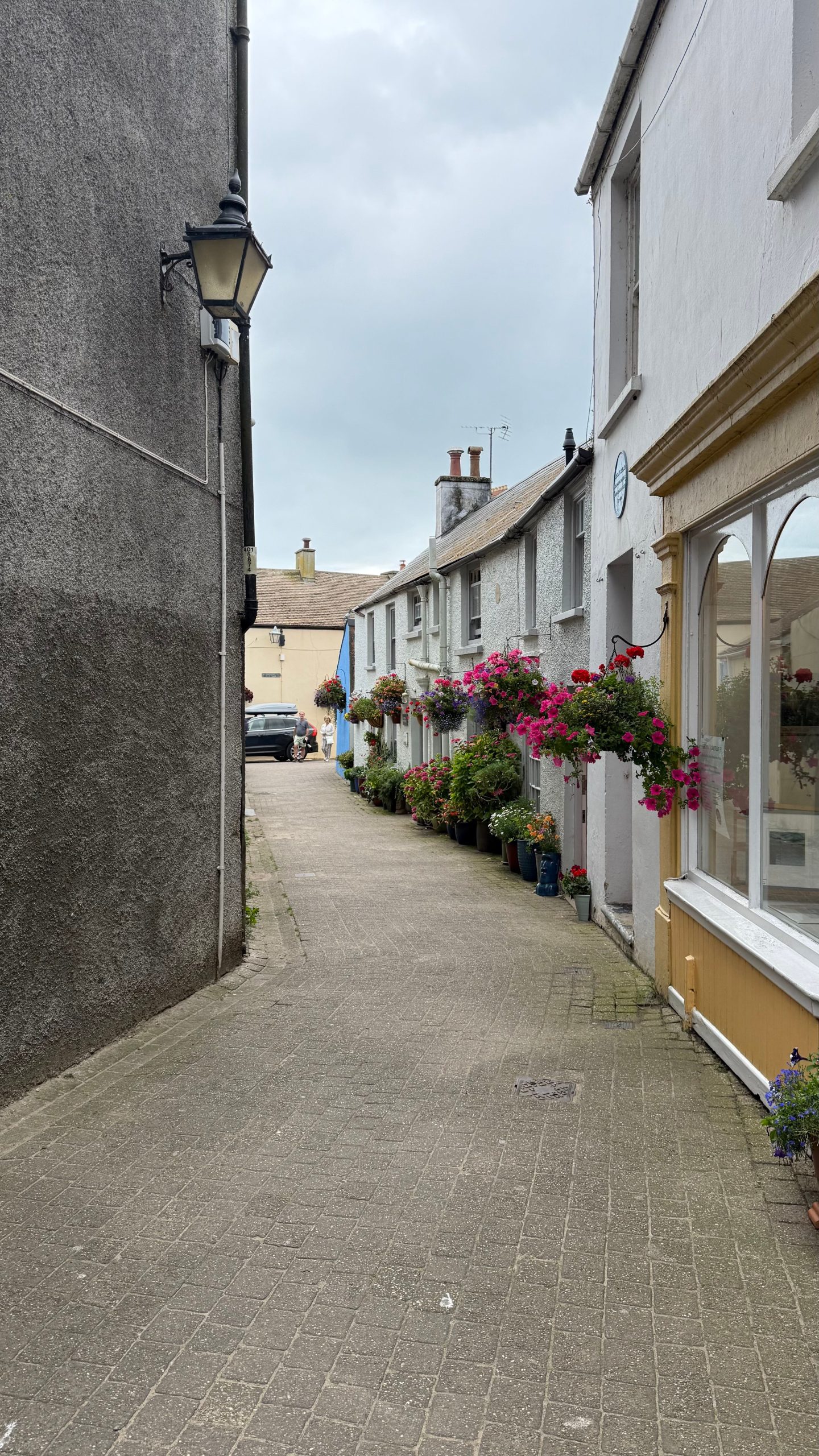 Traditional pedestrian passage decorated with colourful flowers in Camborne, Cornwall