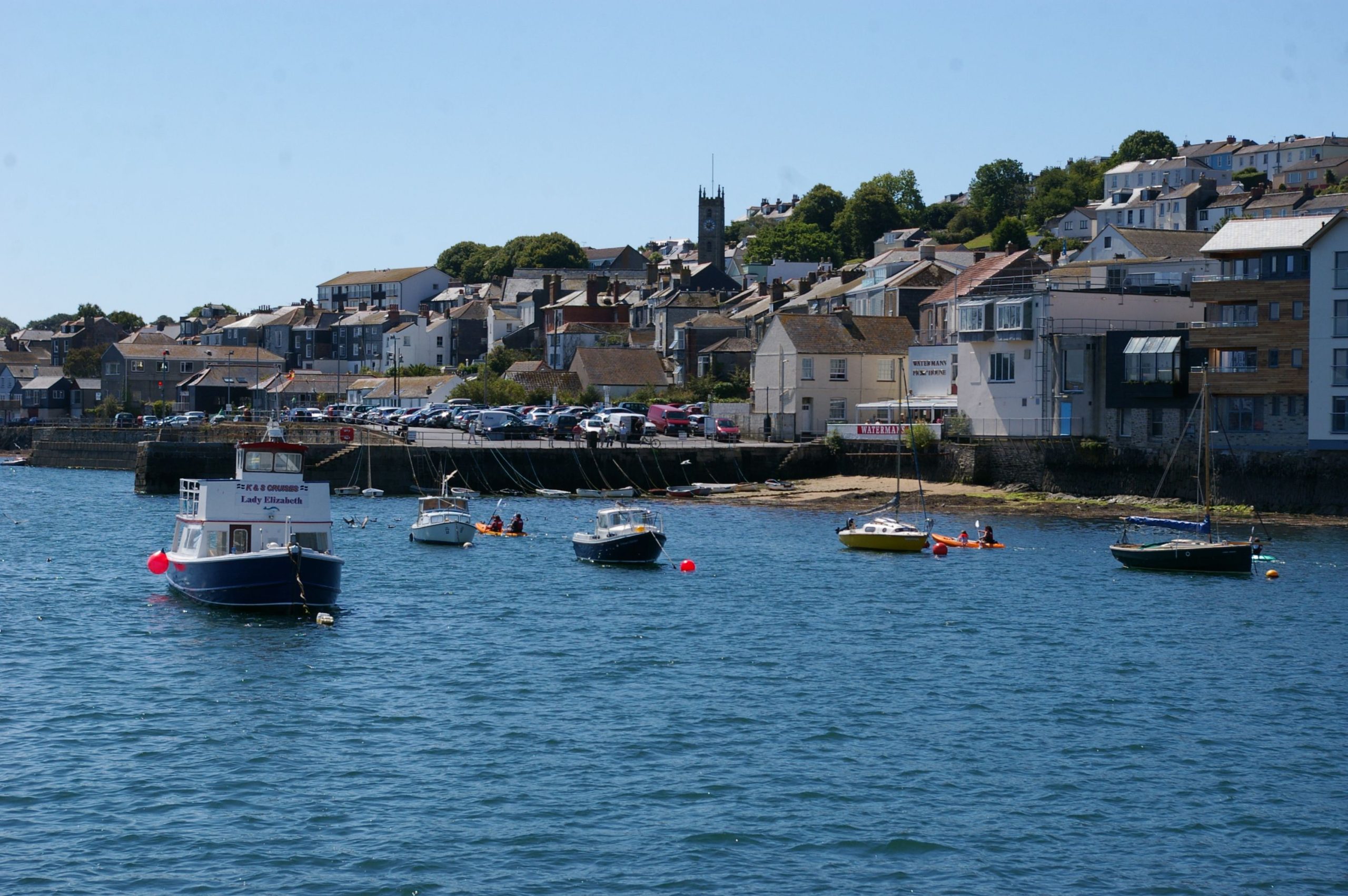 Falmouth waterfront with traditional buildings, boats and hillside houses in Cornwall