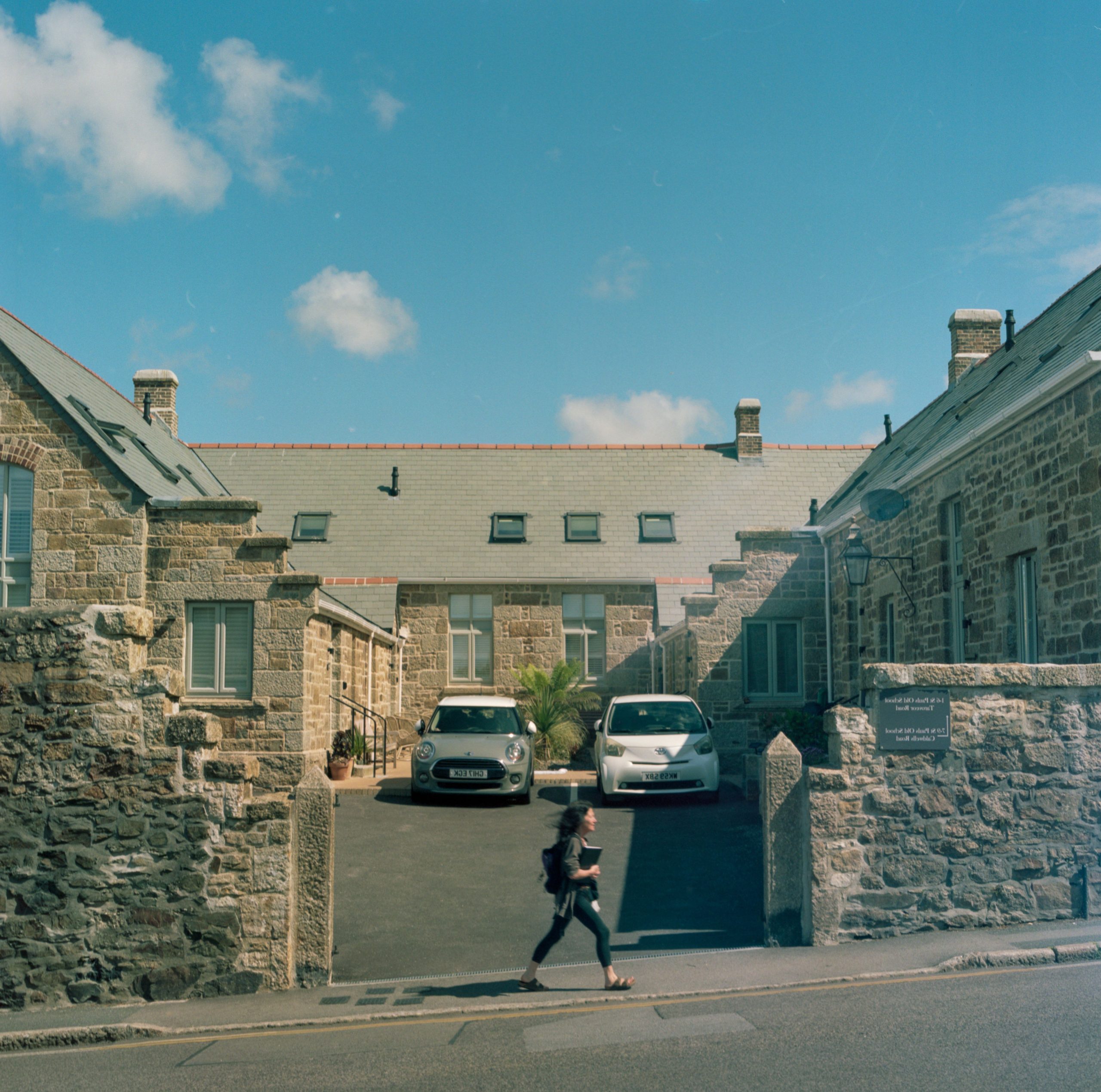 Traditional stone buildings with slate roofs and courtyard entrance in Cornwall