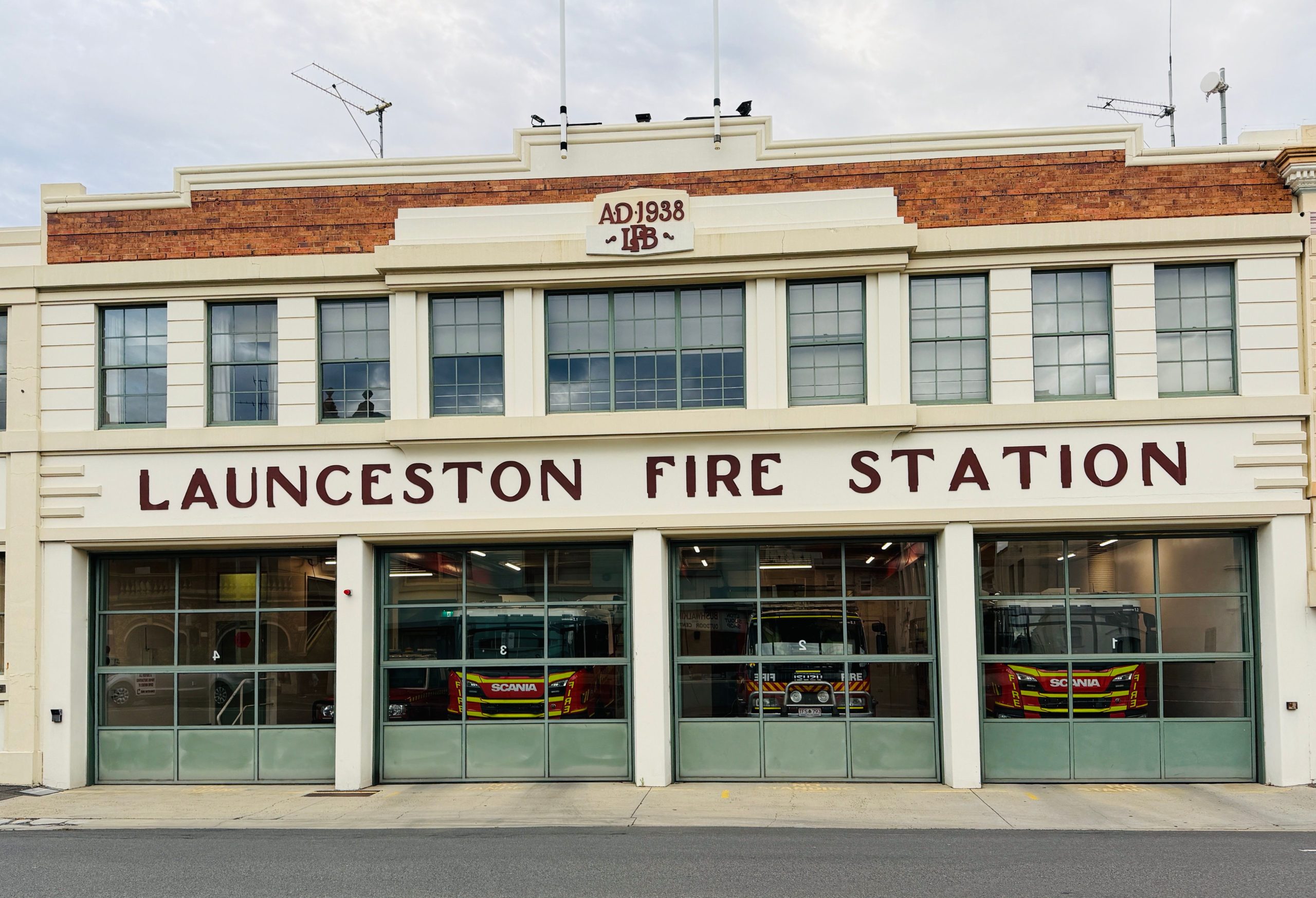 Historic Launceston Fire Station with 1938 façade and fire engines behind glass doors