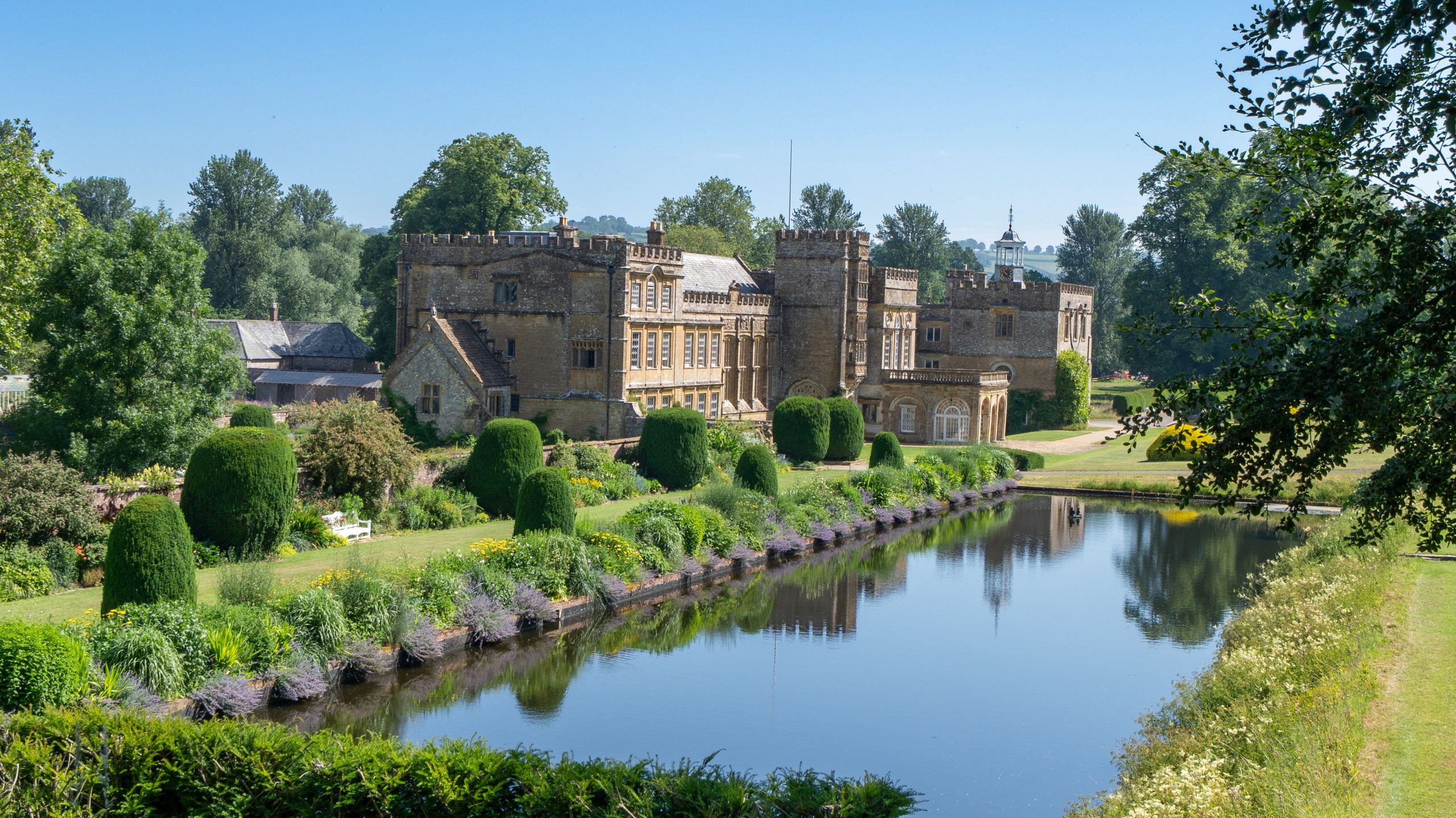 Sherborne Castle and landscaped gardens beside the lake in Dorset