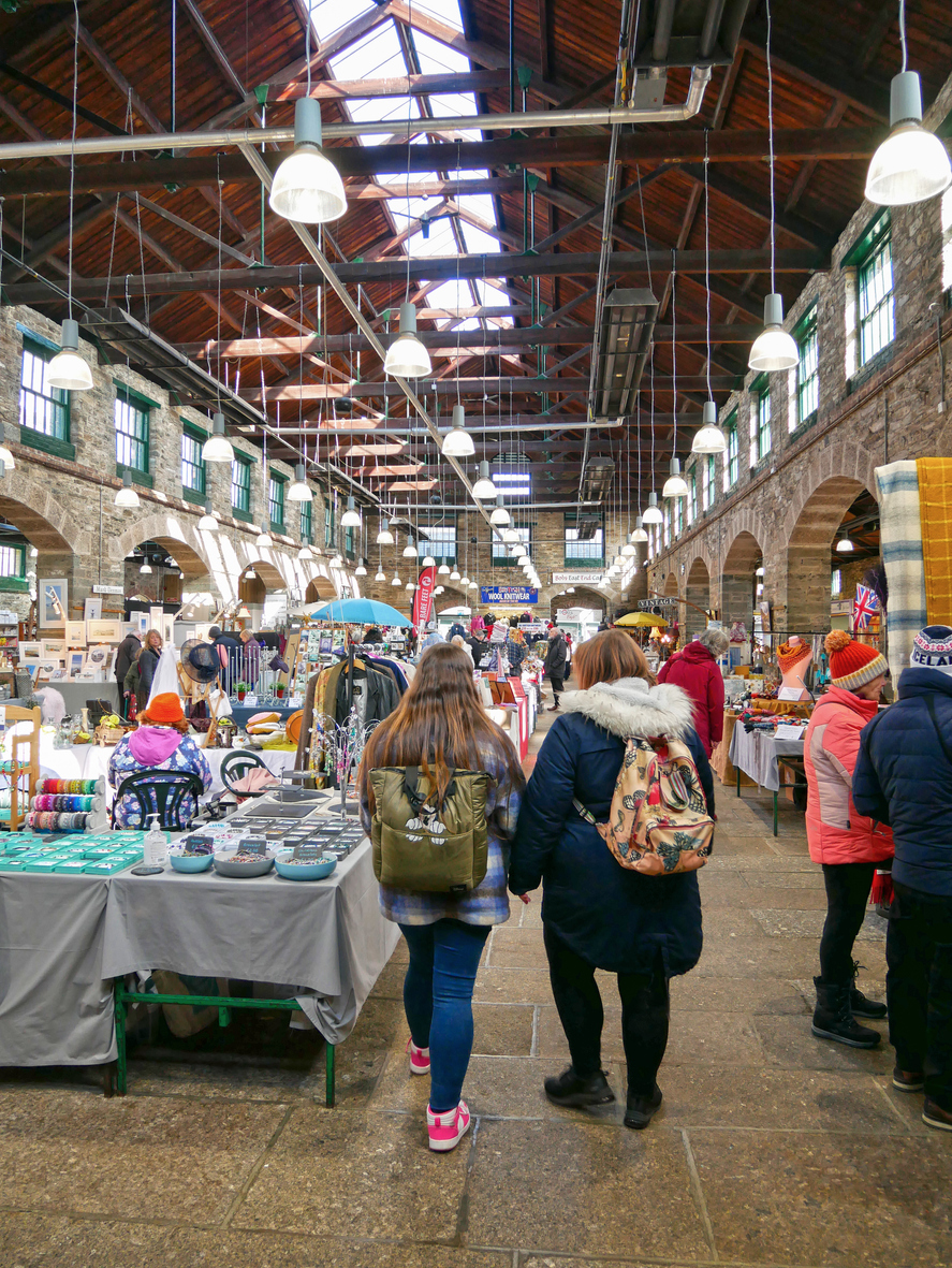 Inside Tavistock Pannier Market with local traders and shoppers