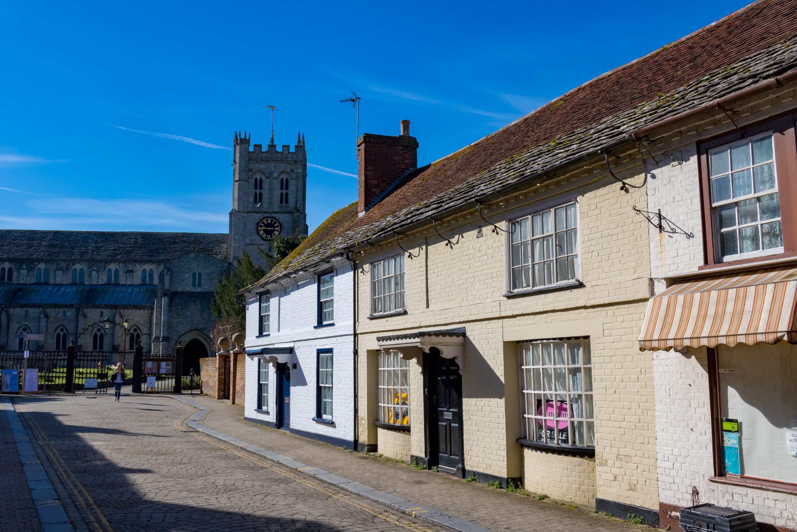 Christchurch Priory beside traditional houses in Christchurch, Dorset