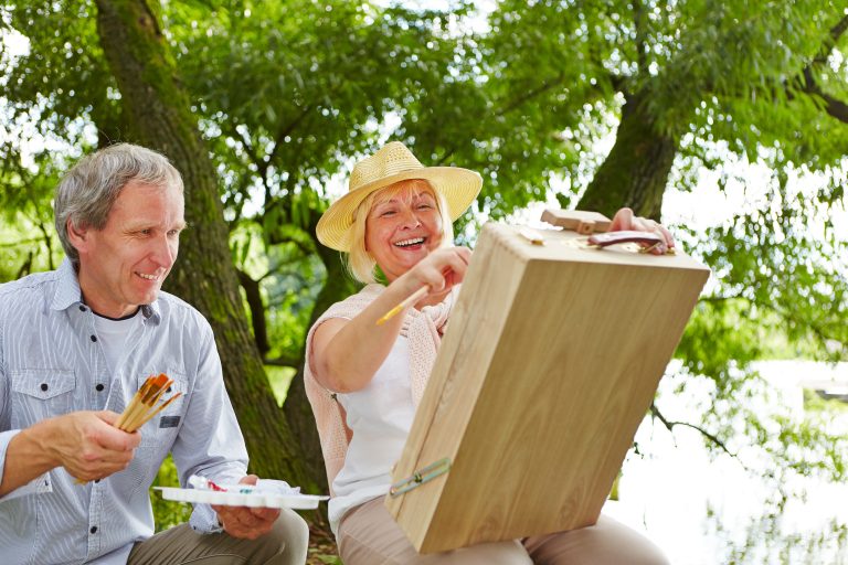Older adults enjoying a painting activity with Companionship Care at Home
