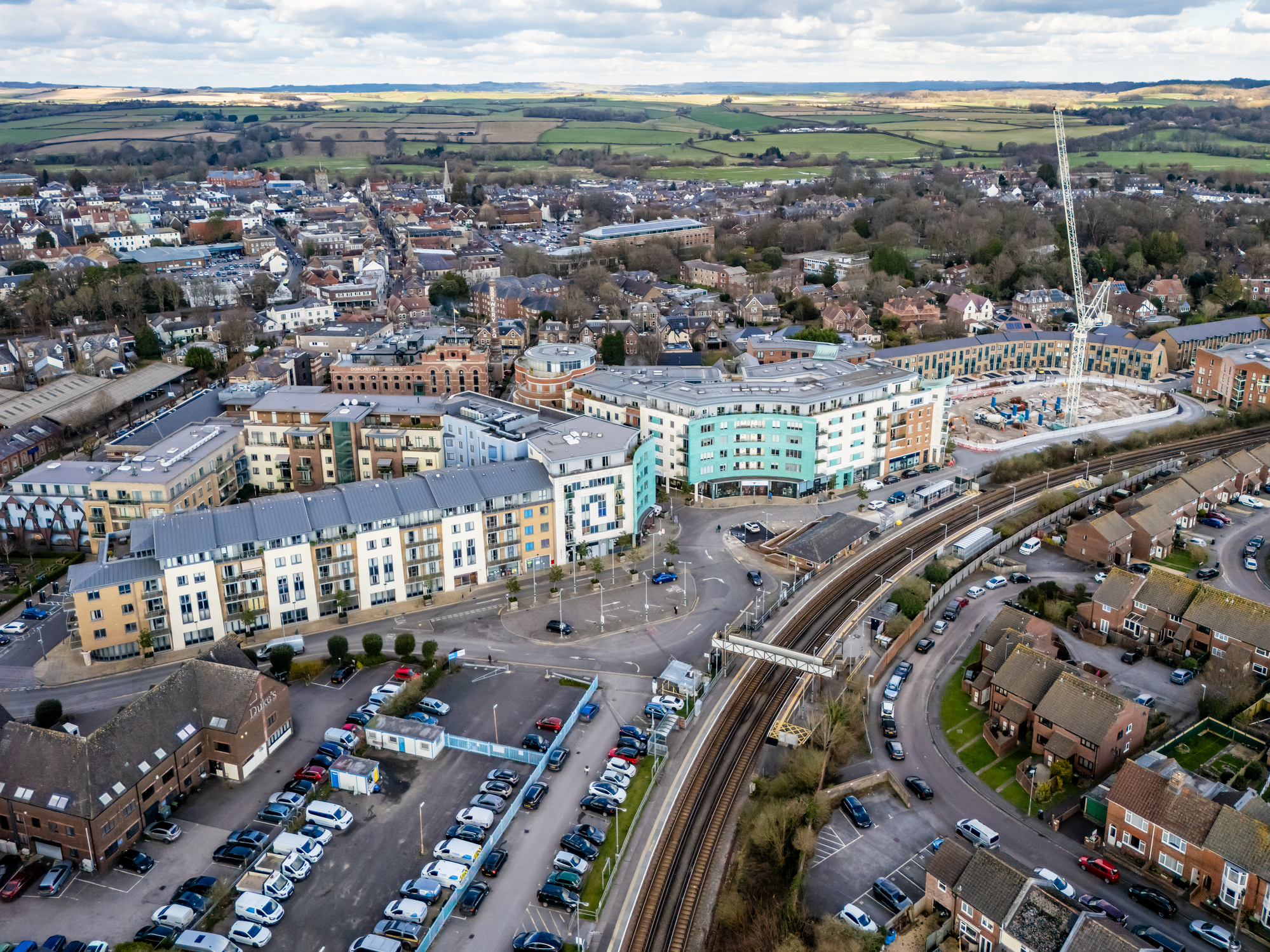 Aerial view of Dorchester South railway station, town and surrounding Dorset countryside