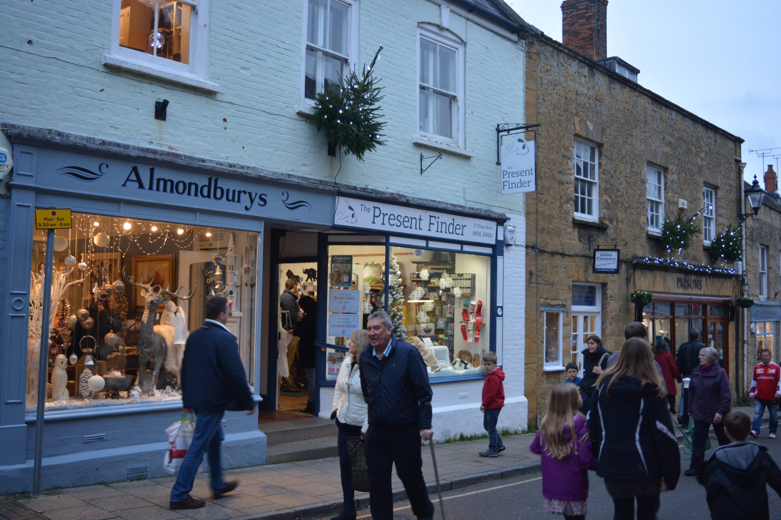 Shoppers and independent shops on Cheap Street in Sherborne, Dorset