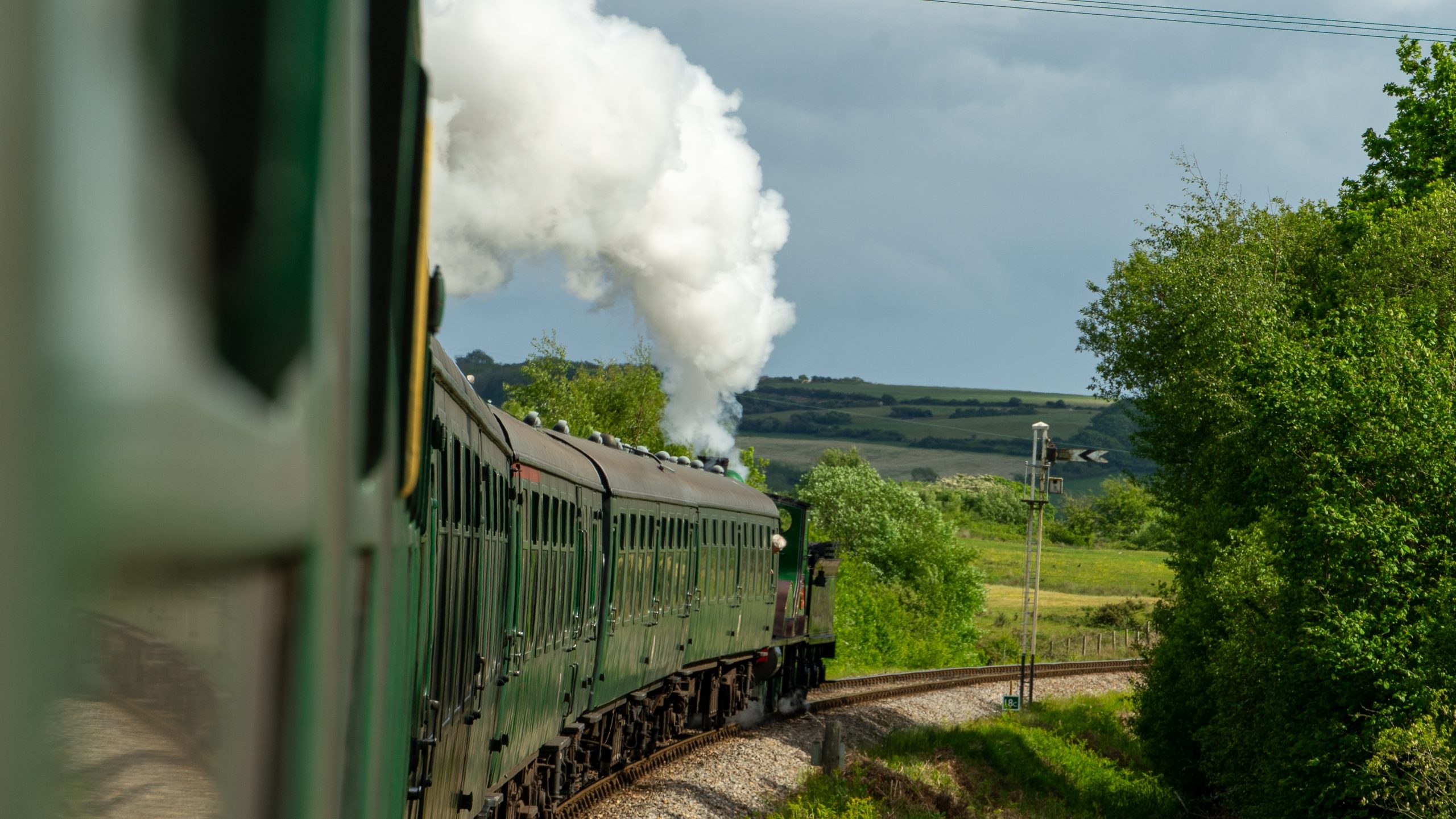 Swanage Railway steam train travelling through the Purbeck countryside in Dorset