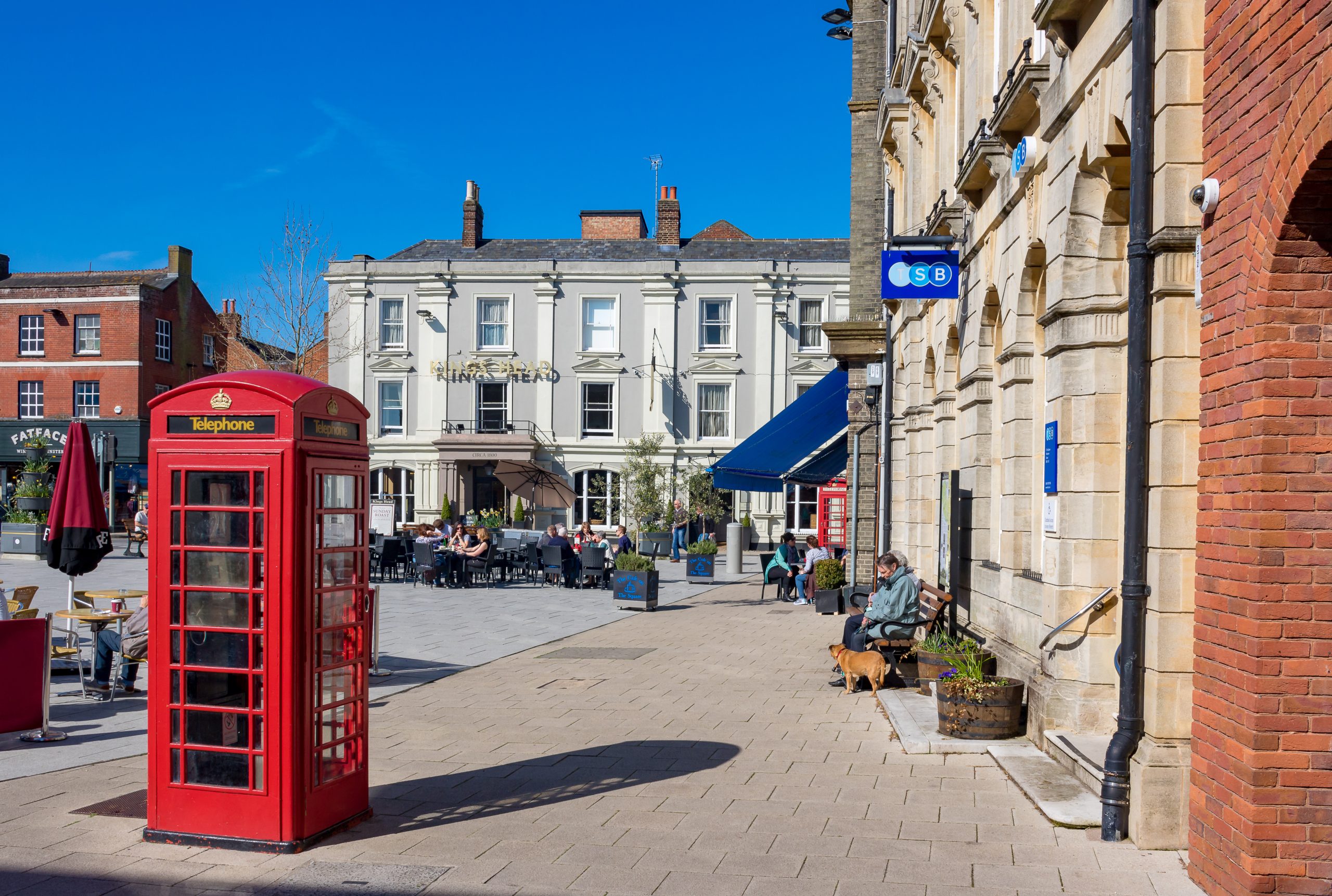 Wimborne town centre with shops, cafés and traditional red telephone boxes in Dorset