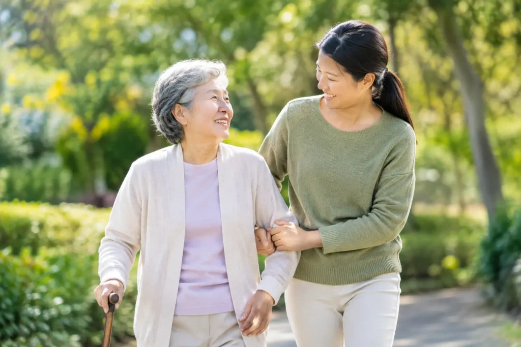 Older woman with a walking stick enjoying a walk with another woman