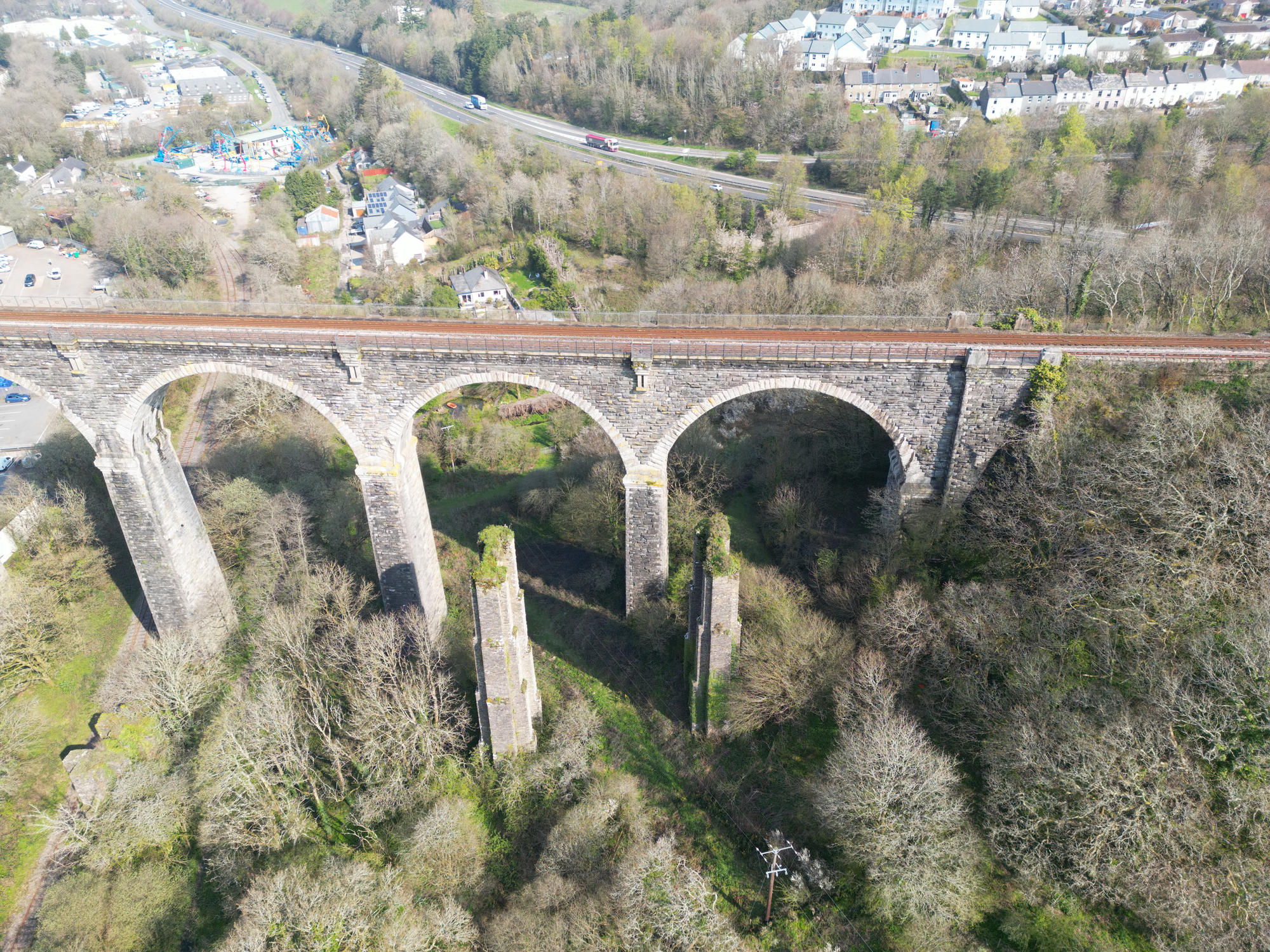 Aerial view of the historic railway viaduct crossing a wooded valley in Liskeard Cornwall