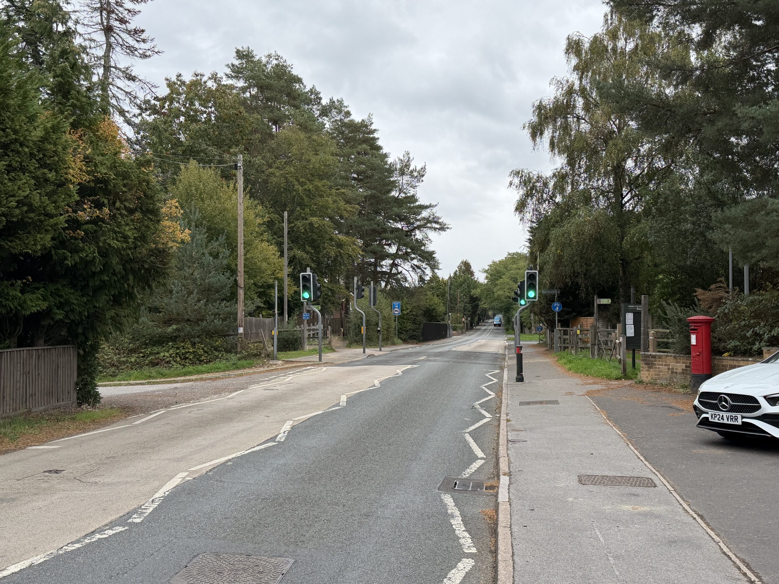 Woodland ringwood road with pedestrian crossing and mature trees in Ashley Heath, Dorset.