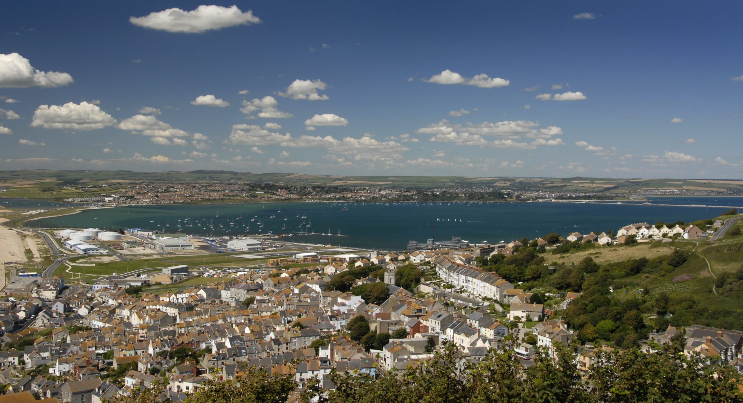 View across homes on the Isle of Portland towards Portland Harbour and Weymouth in Dorset