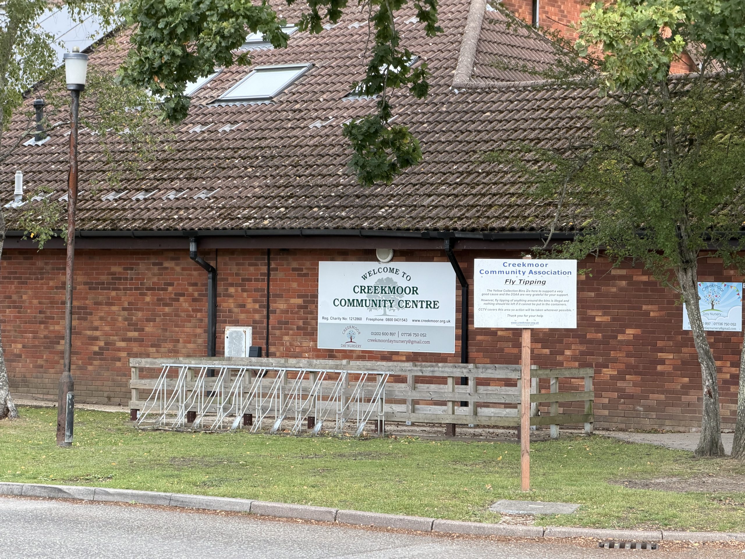 Creekmoor Community Centre in Poole, Dorset, with its red-brick exterior and community noticeboards.