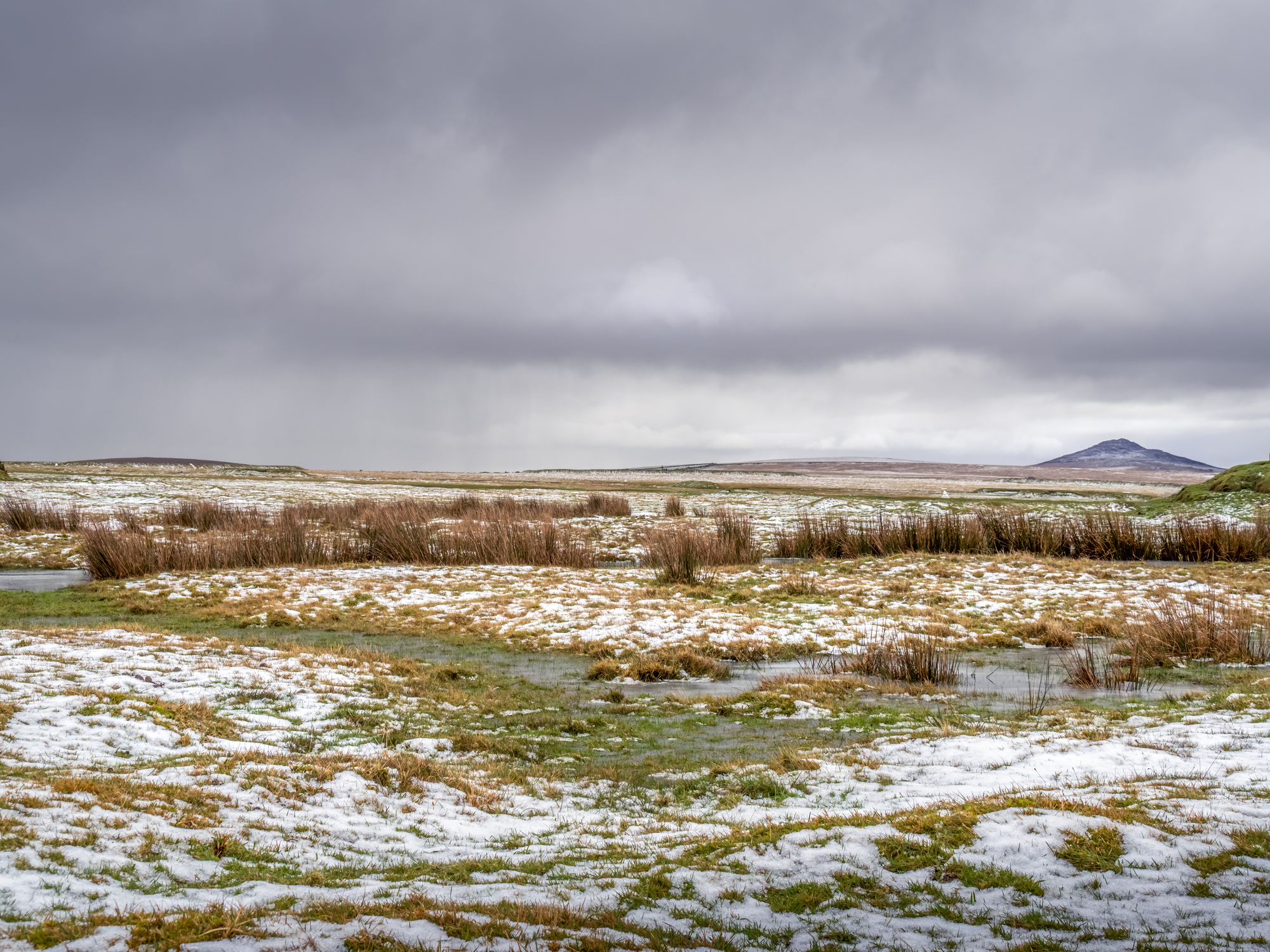 Snow-dusted Davidstow Moor near Camelford in Cornwall beneath a cloudy winter sky