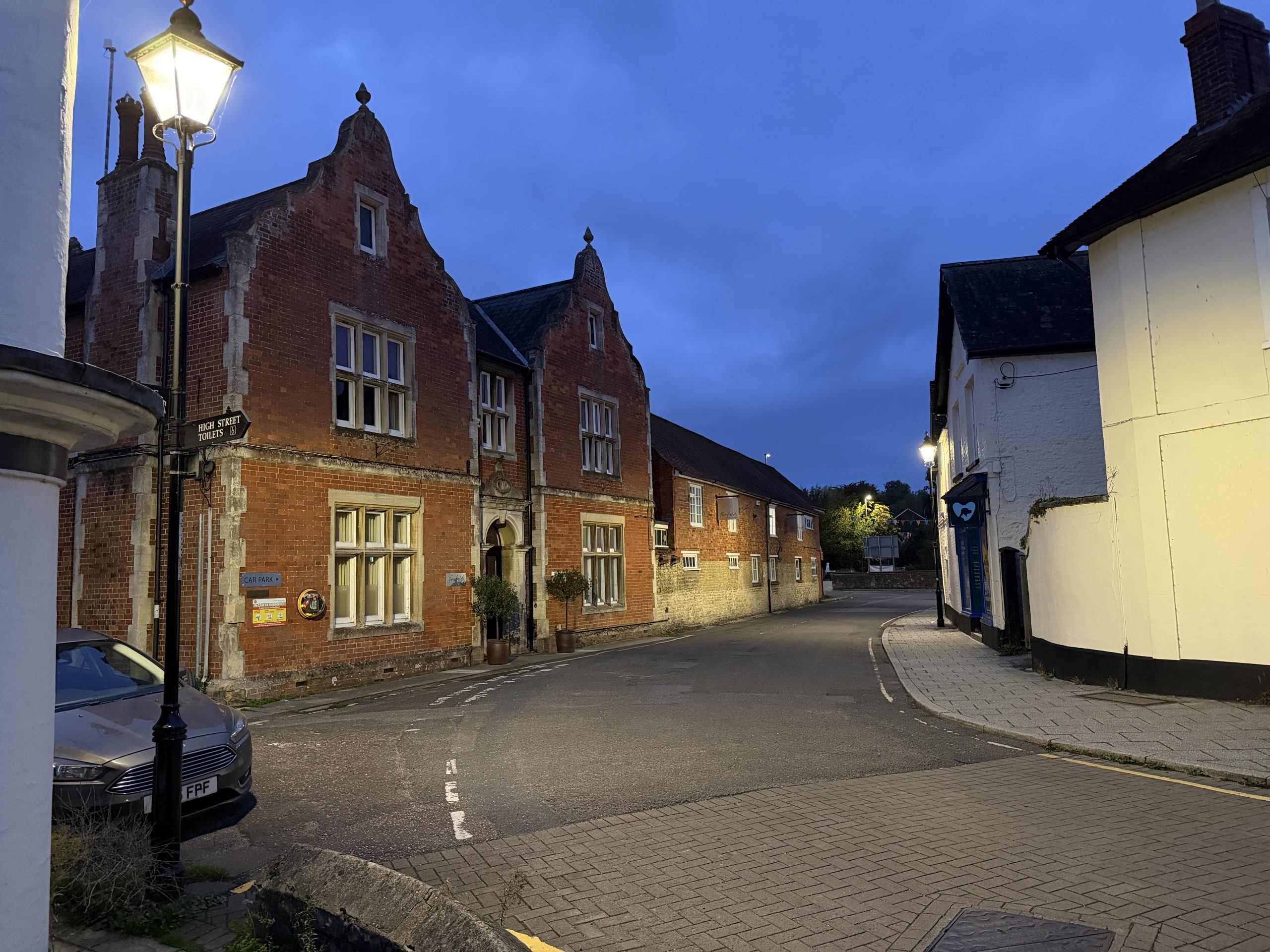 Historic red-brick buildings along a traditional street in Gillingham, Dorset.