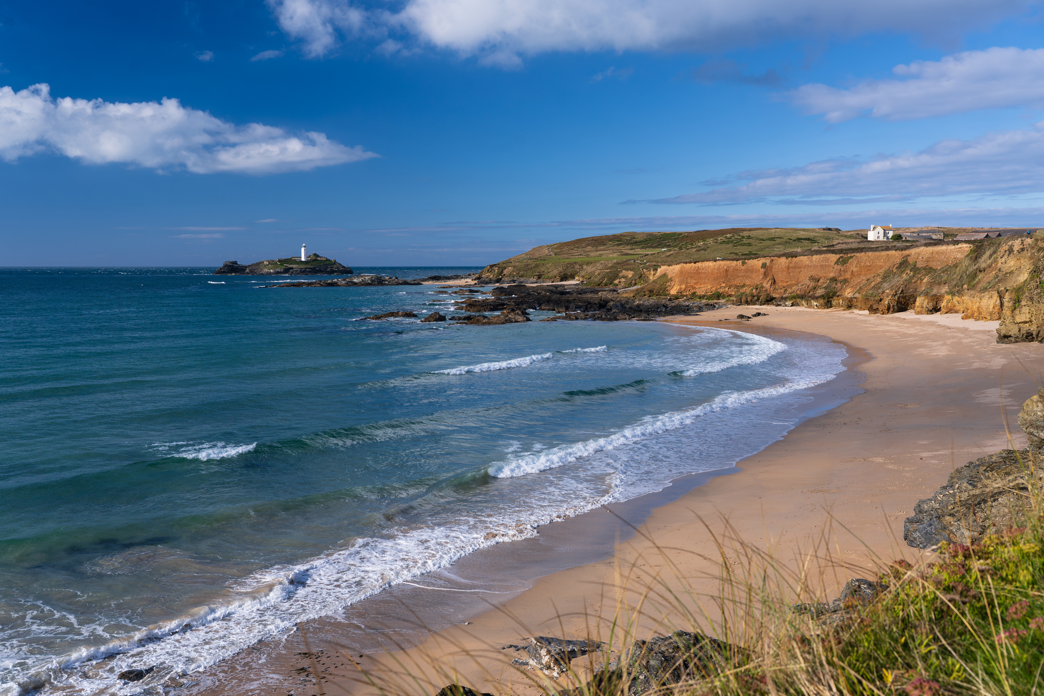 Godrevy Lighthouse overlooking a sandy beach and the Cornish coastline near Hayle