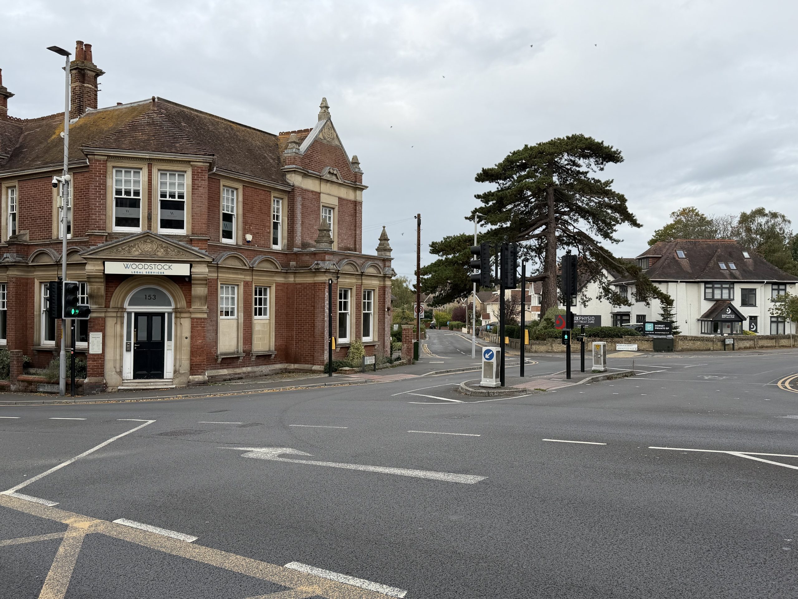 Historic red-brick building with decorative stonework at a road junction in Parkstone, Poole, Dorset.