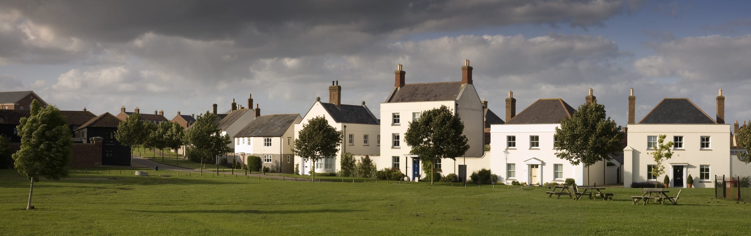 Homes overlooking a green open space in Poundbury, Dorset