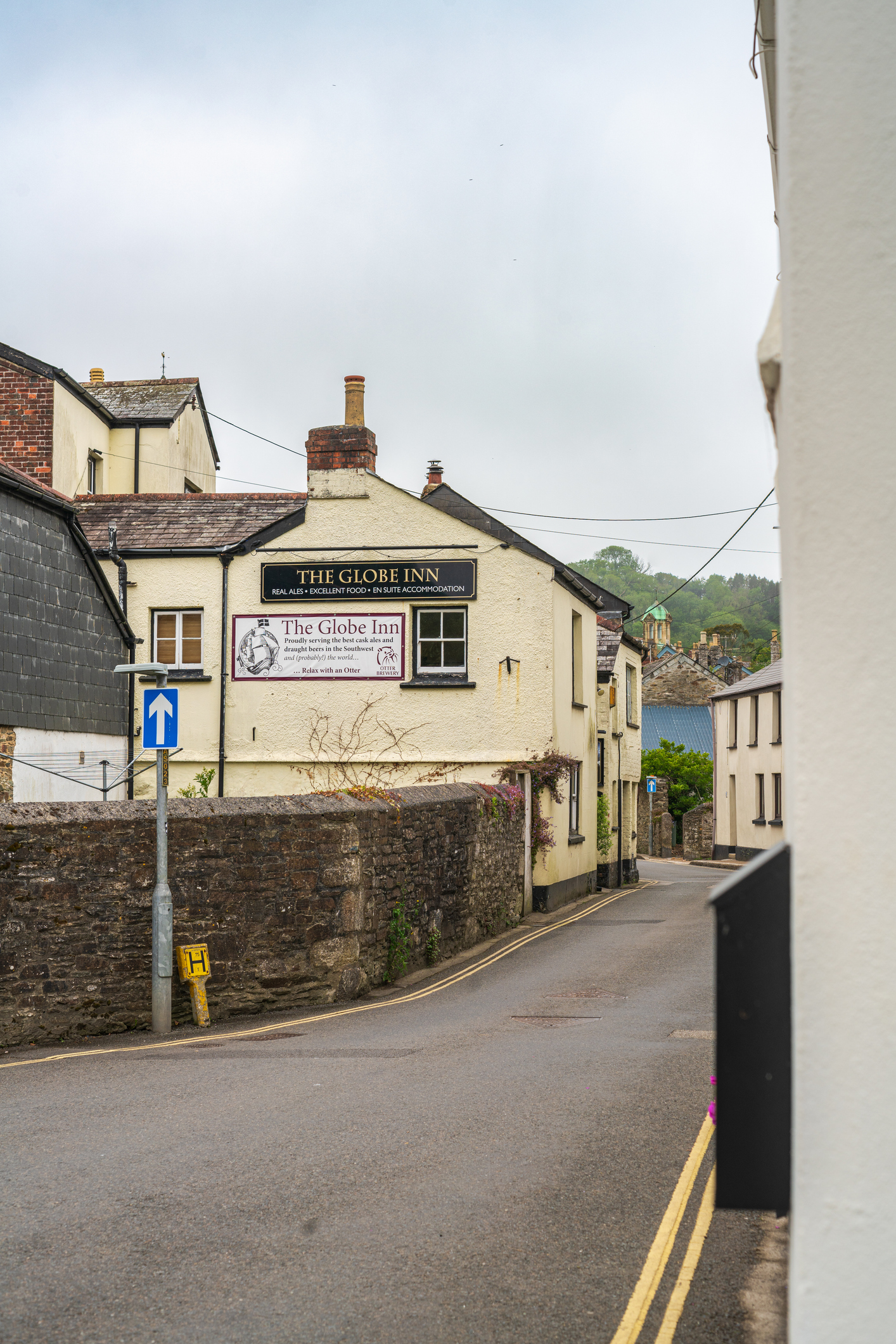 The Globe Inn on a quiet narrow street lined with traditional buildings in Lostwithiel, Cornwall.