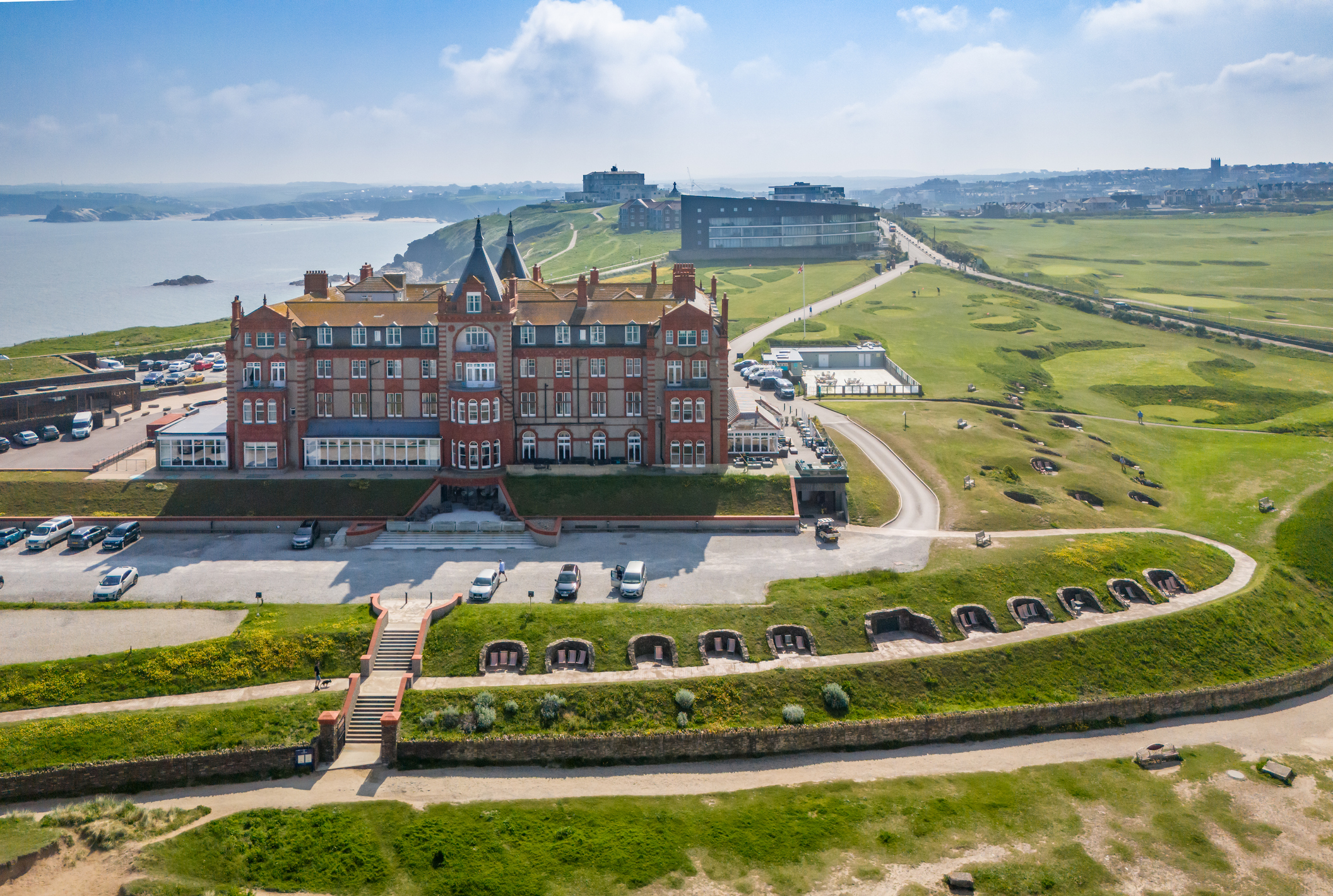 Aerial view of the Headland Hotel overlooking the coastline and golf course in Newquay, Cornwall.