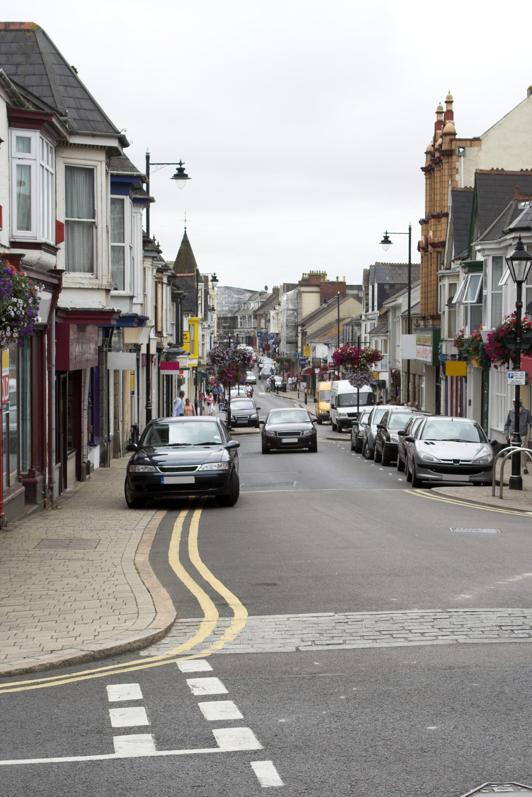 Camborne town centre shopping street with traditional shops and historic buildings in Cornwall