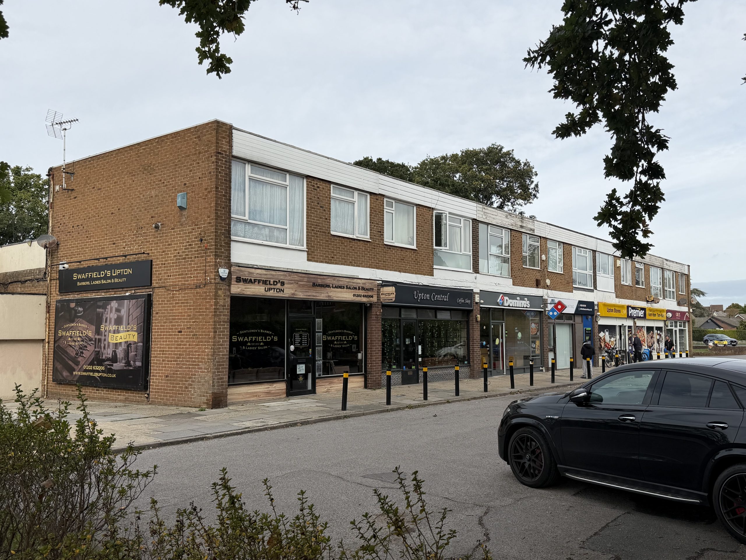 Local shops and businesses along the shopping parade in Upton, Dorset.
