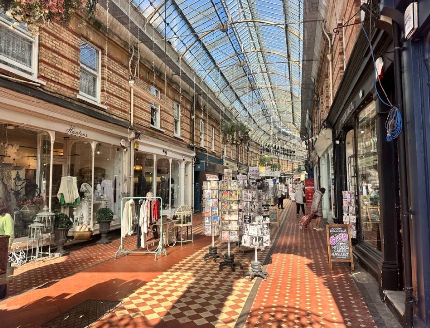 Westbourne Arcade in Bournemouth, Dorset, featuring independent shops beneath its historic glass roof.