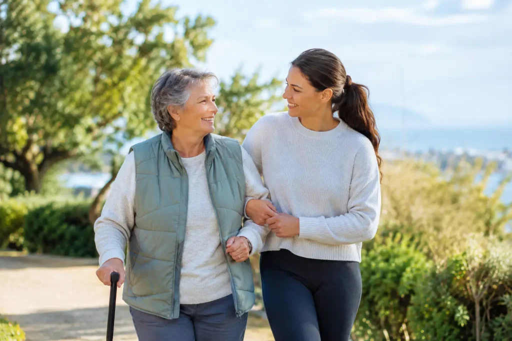 Older woman walking with a younger woman beside her outdoors